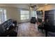 Comfortable living room features a fireplace, large window, tile floor, and comfortable leather seating at 1517 Stanley Dr, Erie, CO 80516