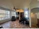 Comfortable living room with fireplace, ceiling fan, large window and a piano at 1517 Stanley Dr, Erie, CO 80516