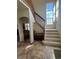 Open staircase with carpeted steps and large window provides natural light and adds architectural detail at 1517 Stanley Dr, Erie, CO 80516