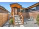 Modern home featuring a stylish front entrance with wood accents and a well-maintained landscape at 2065 Depew St, Edgewater, CO 80214
