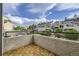 Balcony featuring wood tile flooring and complex views of nearby homes and green spaces at 1830 Newland Ct # 209, Lakewood, CO 80214