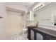 Bathroom features white tile floors, a vanity, and a tub and shower combination at 1830 Newland Ct # 209, Lakewood, CO 80214