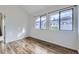 Bright bedroom featuring two windows and beautiful wood-style flooring at 1830 Newland Ct # 209, Lakewood, CO 80214