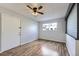 Neutral guest bedroom features a large window and wood floors in a naturally lit space at 1830 Newland Ct # 209, Lakewood, CO 80214