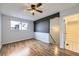 Clean bedroom features a ceiling fan, neutral walls, and wood floors leading to an ensuite bathroom at 1830 Newland Ct # 209, Lakewood, CO 80214