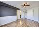 Spacious bedroom with wood floors leading to a closet and ensuite bathroom with lots of sunlight at 1830 Newland Ct # 209, Lakewood, CO 80214