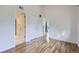 Bedroom view showcasing wood-style flooring, walk in closet, and easy bathroom access at 1830 Newland Ct # 209, Lakewood, CO 80214