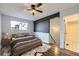 Cozy main bedroom with a ceiling fan, neutral walls, and a large window for lots of natural light at 1830 Newland Ct # 209, Lakewood, CO 80214