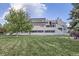 Apartment building with well-maintained lawn and mature landscaping at 1830 Newland Ct # 209, Lakewood, CO 80214