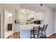 Functional kitchen featuring white cabinetry, a breakfast bar with seating and views to the bathroom at 1830 Newland Ct # 209, Lakewood, CO 80214
