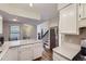 Bright, open-concept kitchen flows to the living area and features white cabinetry and modern appliances at 1830 Newland Ct # 209, Lakewood, CO 80214