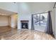 Bright living room features a fireplace, wood floors, and large windows that offer lots of natural light at 1830 Newland Ct # 209, Lakewood, CO 80214