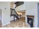 View of the living room leading to the stairway and kitchen that includes wood floors and a fireplace at 1830 Newland Ct # 209, Lakewood, CO 80214