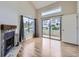 Bright living room features a fireplace, wood floors, and sliding doors leading to an outdoor balcony at 1830 Newland Ct # 209, Lakewood, CO 80214