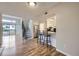 Open-concept living space featuring breakfast bar, stairs to the second floor, and a large window at 1830 Newland Ct # 209, Lakewood, CO 80214