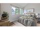 Tranquil main bedroom featuring wood floors, two windows, and neutral décor for a relaxing atmosphere at 1830 Newland Ct # 209, Lakewood, CO 80214