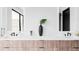 Modern bathroom featuring double vanity, wood cabinetry, and sleek fixtures at 545 Strada Rossa Rd, Golden, CO 80401