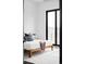 Bright bedroom featuring a minimalist design, plush rug, and a private patio at 545 Strada Rossa Rd, Golden, CO 80401