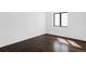 Bedroom featuring dark wood floors, white walls, with ample natural light at 545 Strada Rossa Rd, Golden, CO 80401