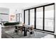 Modern dining room with sleek table, chairs, and large sliding glass doors providing scenic views at 545 Strada Rossa Rd, Golden, CO 80401