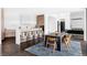 Stylish dining area adjacent to an open kitchen, featuring modern cabinetry and island seating at 545 Strada Rossa Rd, Golden, CO 80401