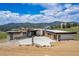 Stunning contemporary home with stone accents and a large concrete driveway, set against a scenic mountain backdrop at 545 Strada Rossa Rd, Golden, CO 80401