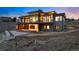 Contemporary home boasting multiple balconies with floor-to-ceiling windows overlooking backyard at 545 Strada Rossa Rd, Golden, CO 80401