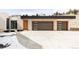 Modern garage with two doors and a concrete driveway at 545 Strada Rossa Rd, Golden, CO 80401