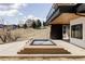 A modern hot tub on a concrete patio with a house on a hillside in the background at 545 Strada Rossa Rd, Golden, CO 80401