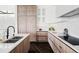 Modern kitchen with custom cabinets, stainless appliances, stone countertops, and hardwood floors at 545 Strada Rossa Rd, Golden, CO 80401