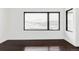 Bright living room with dark wood flooring and a large window showing mountain views at 545 Strada Rossa Rd, Golden, CO 80401