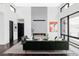 Elegant living room with a contemporary fireplace, large windows, and stylish, comfortable seating at 545 Strada Rossa Rd, Golden, CO 80401