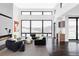 Bright living room featuring large windows, hardwood floors, a fireplace, and modern furnishings at 545 Strada Rossa Rd, Golden, CO 80401