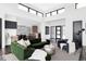 Open-concept living area with a fireplace, hardwood floors, high ceilings, and modern decor at 545 Strada Rossa Rd, Golden, CO 80401
