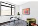 Modern office space featuring large window, glass desk, and unique artwork at 545 Strada Rossa Rd, Golden, CO 80401