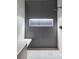 Modern shower featuring gray tile, glass enclosure, and a built-in bench at 545 Strada Rossa Rd, Golden, CO 80401