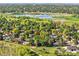 Aerial shot capturing a charming home nestled among lush greenery near a serene lake and verdant landscapes at 12348 Elizabeth Ct, Thornton, CO 80241