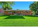 Beautiful backyard featuring a lush lawn and a brick patio, ideal for outdoor entertaining and relaxation at 12348 Elizabeth Ct, Thornton, CO 80241