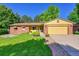 Charming brick and yellow home with a well-manicured lawn and mature trees at 12348 Elizabeth Ct, Thornton, CO 80241