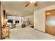 Inviting living room features a white brick fireplace with built-in shelving and plush carpeting at 12348 Elizabeth Ct, Thornton, CO 80241