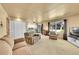 Open living space with large windows, neutral tones, and access to a kitchen and outdoor space at 12348 Elizabeth Ct, Thornton, CO 80241