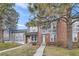 Brick townhouse with a green door and walkway at 1233 S Flower Cir # D, Lakewood, CO 80232