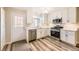 Modern kitchen with white cabinets and stainless steel appliances at 1233 S Flower Cir # D, Lakewood, CO 80232