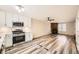 Modern kitchen with white cabinets, stainless steel appliances and living room view at 1233 S Flower Cir # D, Lakewood, CO 80232