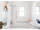 Clean bathroom with white tile, shower/tub combo, and modern fixtures at 1431 S Emerson St, Denver, CO 80210