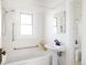 Clean bathroom with a pedestal sink and shower/tub combo at 1431 S Emerson St, Denver, CO 80210