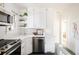 Modern kitchen with white cabinets, quartz countertops, and stainless steel appliances at 1431 S Emerson St, Denver, CO 80210