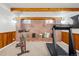 Basement gym with exposed brick, bench seating, a treadmill, and an exercise bike at 2042 Jamaica St, Aurora, CO 80010