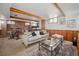 Cozy basement living area with exposed wooden beams, creating a warm and inviting space at 2042 Jamaica St, Aurora, CO 80010