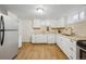 Basement kitchen with white cabinets and stainless steel appliances at 2042 Jamaica St, Aurora, CO 80010